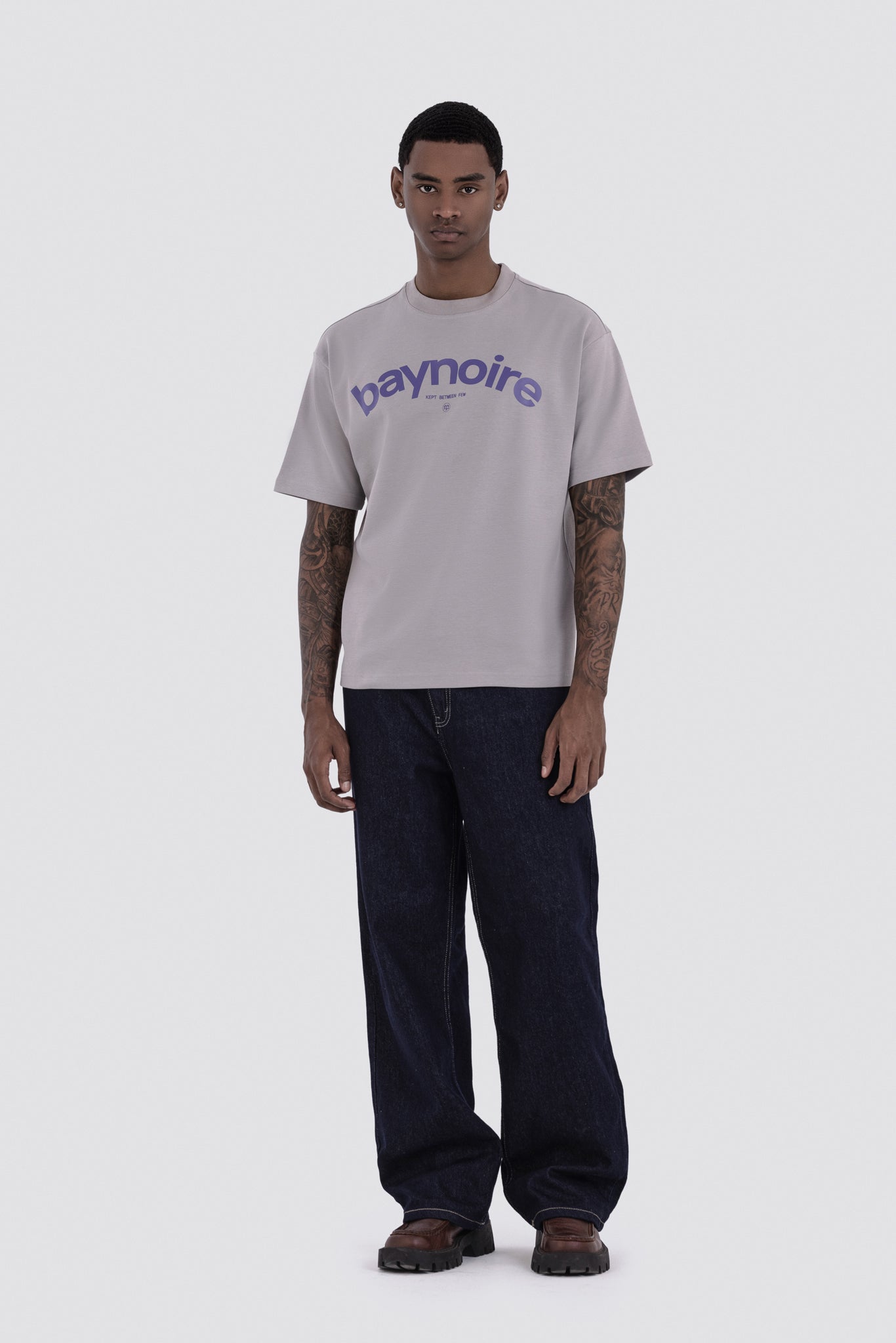 Man wearing a gray t-shirt with 'baymoire' logo on a white background