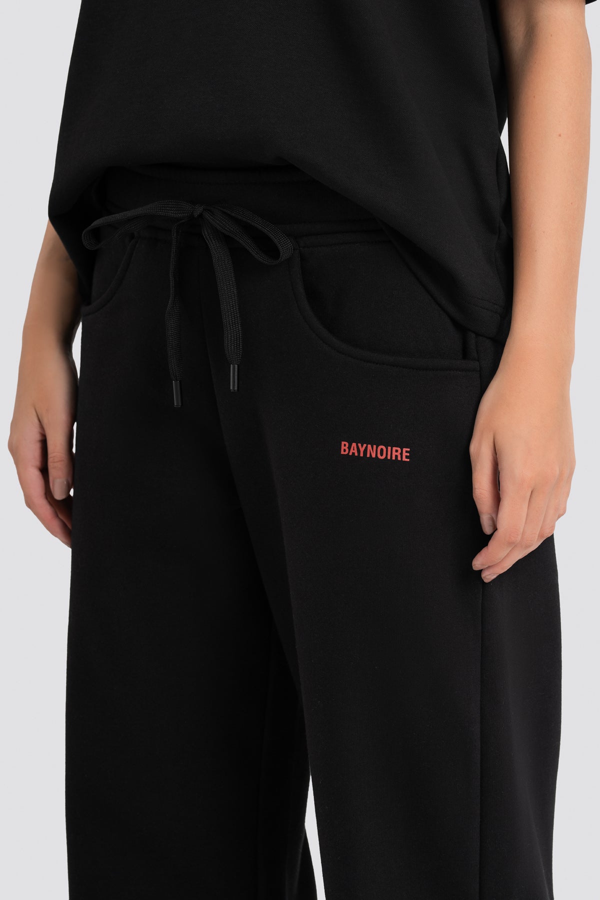 Black pants with 'BAYNOIRE' branding on a white background